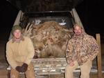 Scott and Tony, with a stack of Kansas coyotes.