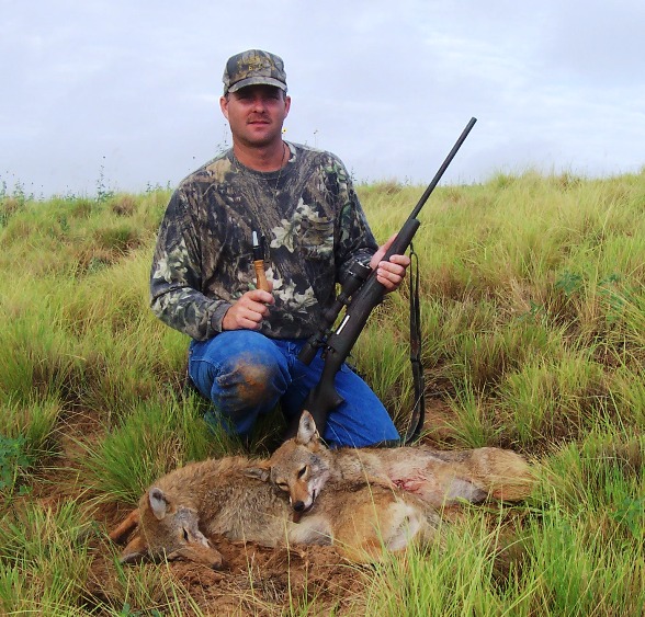 Joe Allison and a pair of howled up Okie coyotes.