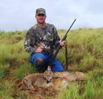 Joe Allison and a pair of howled up Okie coyotes.